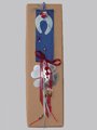Χριστουγεννιάτικο γούρι σε κουτί, με μεγάλη  υφασμάτινη κορδέλα, τετράφυλλο τριφύλλι από αλπακά, χάντρες και κορδελάκια